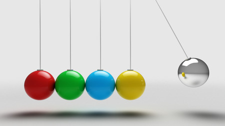 Colorful Balancing balls newtons cradle over light grey backgroundの写真素材