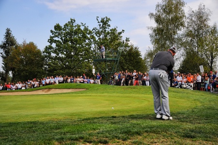Turin Italy circa September 2016 Unknown golf player concentrate looking for the right line standing on the green with wide blurred crowd in the backgroundのeditorial素材