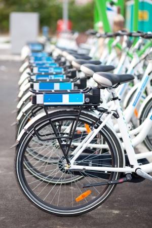 Row of electric bicycles parking in city stationの写真素材