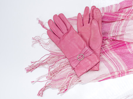  leather gloves and a pink and white scarfの写真素材