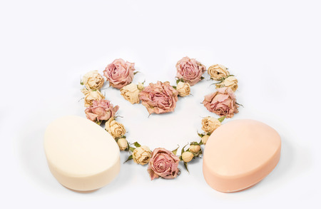 two bars of soap and a lot of small rosesの写真素材