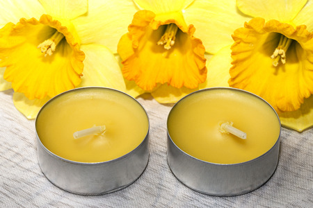 yellow candles and yellow daffodilsの写真素材