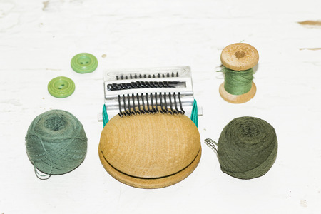 buttons, darning machine, thread on an old painted wooden surfaceの写真素材