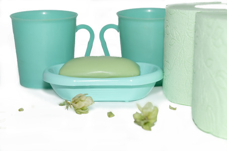 green mugs, two rolls of toilet paper and soap closeupの写真素材