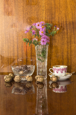 crystal vases of flowers and candy on a polished surfaceの写真素材