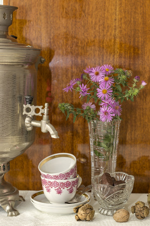 flowers, samovar, tea cups and chocolatesの写真素材