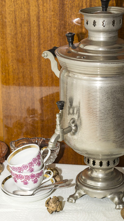 metal samovar and tea cups with spoonsの写真素材