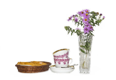 tea cups, white bread in a basket and flowersの写真素材