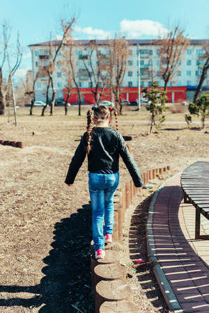 Girl walks in the park on a sunny dayの写真素材