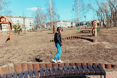 Girl walks in the park on a sunny dayの写真素材