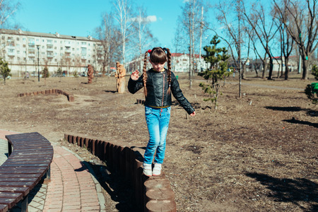 Girl walks in the park on a sunny dayの写真素材