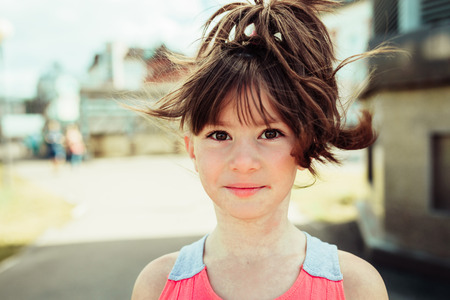little girl walks in summer cityの写真素材