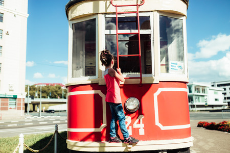 little girl walks in summer cityの写真素材
