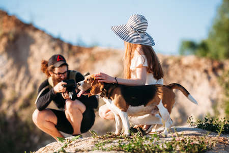 Portrait of a photographer taking pictures of a girl and a dog in nature.illustrative editorialのeditorial素材
