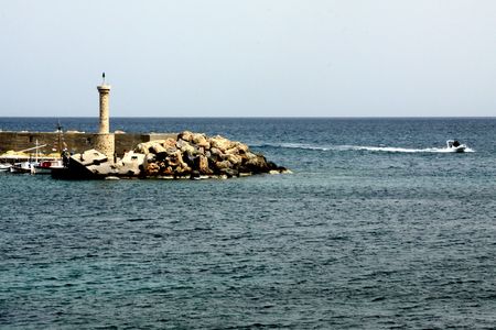 crete greece lighthouse with boatの写真素材
