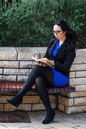 Portrait of young attractive woman with glasses and old bookの写真素材