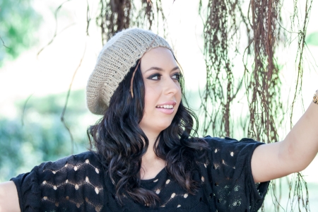 beautiful woman in hat posing in the parkの写真素材