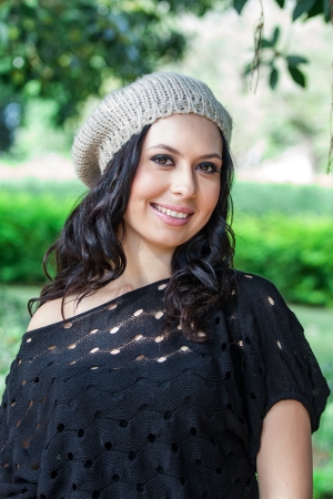 beautiful woman in hat posing in the parkの写真素材