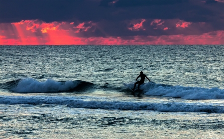 Silhouette of surfer in the seaの写真素材