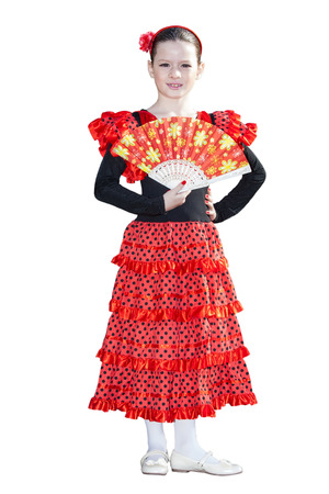 Happy little pretty girl in spanish red dress isolated on whiteの写真素材
