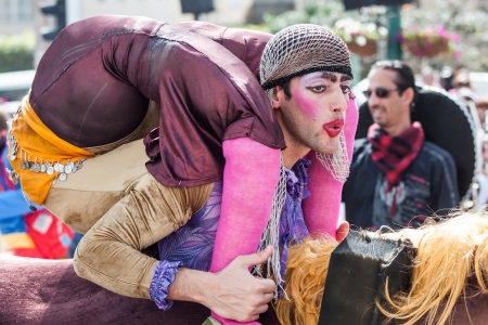 NETANYA, ISRAEL - FEBRUARY 24: Unidentified men dressed as a clown go through the streets of Netanya during a procession on the feast of Purim carnival February 24, 2013 in Netanya, Israel.のeditorial素材