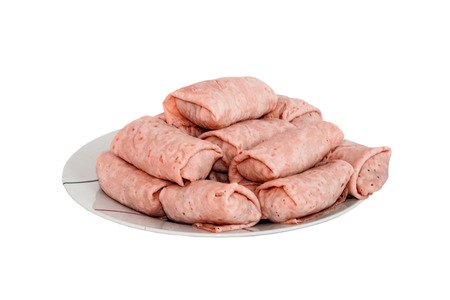 Semi-finished pancakes with filling on plate isolated on white backgroundの写真素材