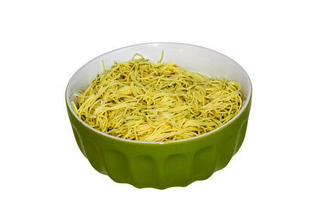 Homemade macaroni and cheese in a green bowl isolated on whiteの写真素材