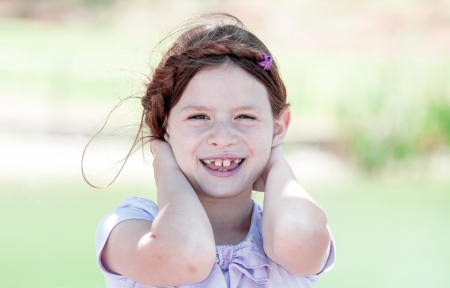 Little girl is  playing with her hairの写真素材