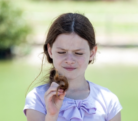 Little girl is  playing with her hairの写真素材