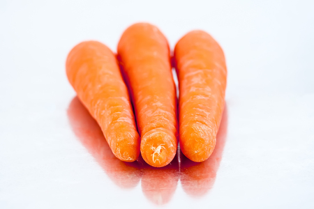 Fresh organic carrots  with mirror reflectionの写真素材