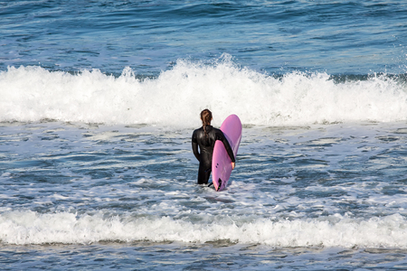 Surfer on the way to the seaの写真素材