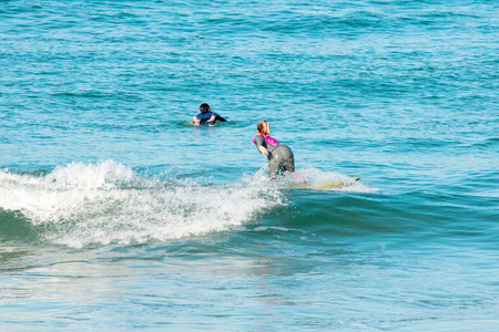 Surfers on the way to the seaの写真素材