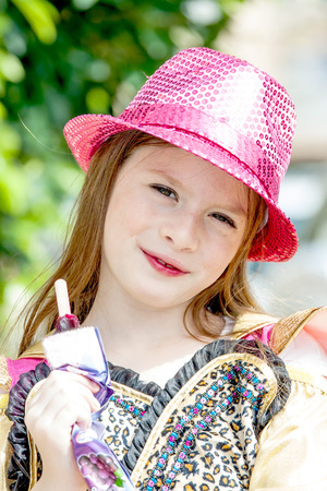 emotional young girl in red hat eating ice creamの写真素材