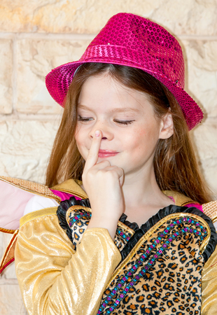 emotional young girl in red hatの写真素材