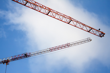 Construction site with move cranes on blue skyの写真素材