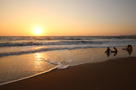 Teenagers on the sand in water of  Ocean Indiaの写真素材