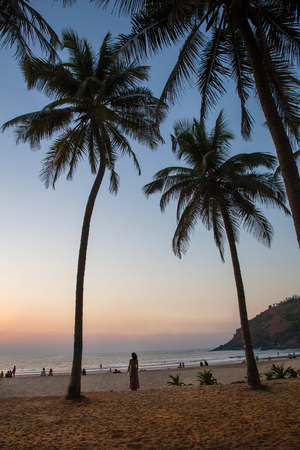 South India. Sunset on beach. Unrecoznizable peopleの写真素材