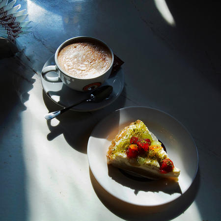 cappuccino and a slice of tasty cake ( cheesecake)の写真素材