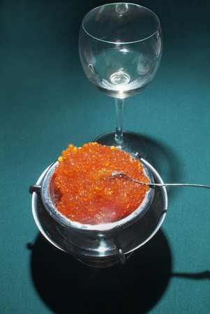 Red  (  Salmon ) Caviar on green table  and  glass of  wineの写真素材