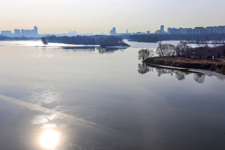 a wonderful sunny day of the beginning of April.  Ice on Moscow River. Some people catst  fish on ice (dangerous). outskirts of Moscowの写真素材