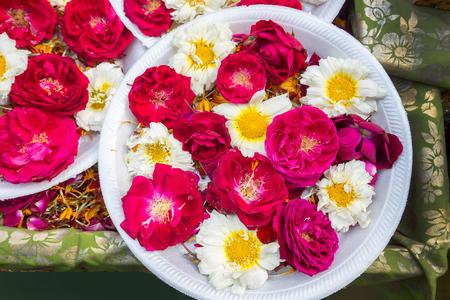 Red and white Flowers on market. Indian on the plate (possible - for religious Hinduism purposes)の写真素材