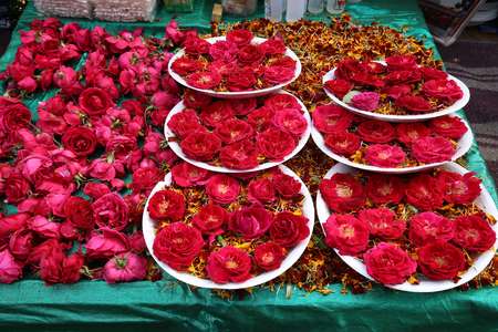 Red Flowers on market. Red Flowers on market. Indian on the plate (possible - for religious Hinduism purposes)の写真素材