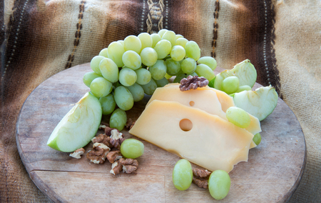 Cheese  and grapes   -  snack or dessert    and pieces of walnutsの写真素材