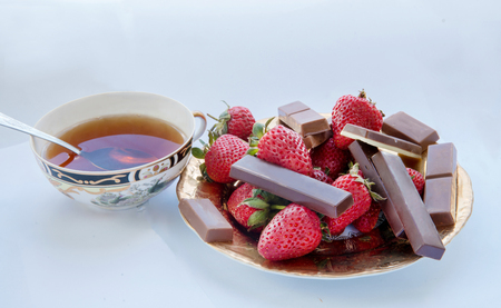 chocolates, strawberries and a cup of tea . Breakfast.の写真素材