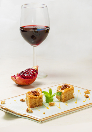 Georgian baklava (pakhlava) - cakes - and bottle of red wineの写真素材