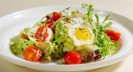 Salad with Fried Egg, Arugula, Tomato and Shrimp, Healthy  food.