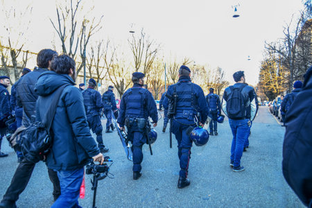 22-02-2014 Milan, Italy. Italian police (Carabineries)in baton-equipped lead the way before an anarchist demonstration in Milan. The helicopter flies higher.のeditorial素材