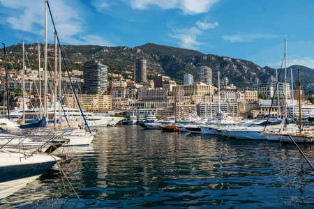 Awe Morning view on boats and yachts (sailboats) in Hercule port and buildings of Monaco and Monte Carlo in right direction with hotels and casino buildings. Mountains above buildings, Fantastic summer for recreation, vacations and travelの写真素材