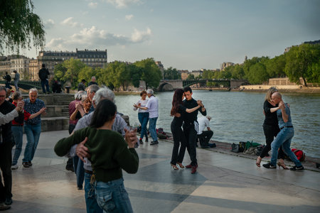 05-14-2023 PARIS FR Tango (there's whole seasonahead) on the riverbank of Seine river in mid May - sunset time now. Water of grea river. In park "Jardin Tino Rossi" next to "Jardin des plants" -healthy lifestyle. Freshness of greenery (trees) on both riveのeditorial素材