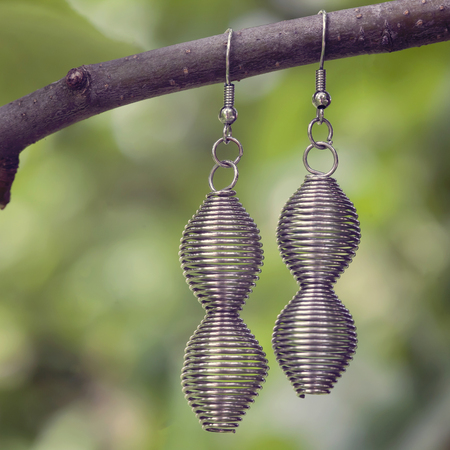 beautiful metal earrings hanging on the treeの写真素材